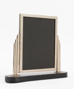 An Art Deco tabletop picture frame, chrome finished metal on ebonised base, circa 1925, 30cm high, 33cm wide