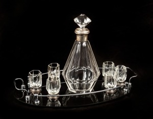 An Austrian Art Deco drink set, faceted clear glass with silver mounts and black glass tray with chrome gallery, circa 1920s, the decanter 27.5cm high