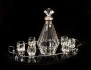 An Austrian Art Deco drink set, faceted clear glass with silver mounts and black glass tray with chrome gallery, circa 1920s, the decanter 27.5cm high