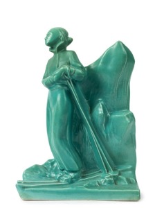 A Belgian green glazed Art Deco sculpture of a skier, incised "Made in Belgium", 32cm high
