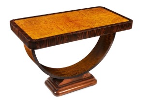 A fine Austrian Art Deco centre table with hoop base, fiddleback maple and macassar ebony on walnut base, circa 1925, 70cm high, 107cm wide, 56cm deep