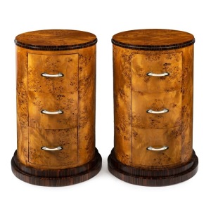 A pair of Austrian Art Deco cylindrical three drawer bedside chests, Karelian birch and macassar ebony with ivorine handles, circa 1925, 77cm high, 48cm diameter