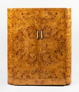 An Art Deco two door gentleman''s wardrobe,&nbsp;Karelian birch with ivorine handles, mid 20th century, has been converted to a bedroom entertainment cabinet (back removed), ​​​​​​​138cm high, 118cm wide, 55cm deep