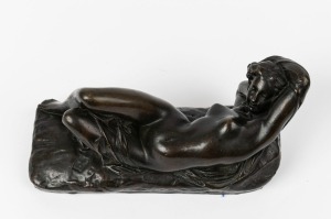 An antique French bronze statue of a reclining female nude, 19th/20th century, foundry button mark near base, 13cm high, 25cm wide