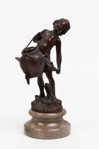A bronze statue of a boy holding a basket, mounted on gray stone plinth, 20th century, 26cm high