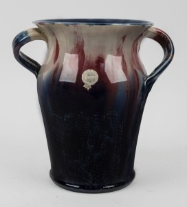 REMUED pottery vase. Rare shape with unusual handles, glazed in blue, pink and cream, incised "Remued, Hand Made, 309", with original foil label, 24cm high, 23cm wide