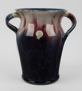 REMUED pottery vase. Rare shape with unusual handles, glazed in blue, pink and cream, incised "Remued, Hand Made, 309", with original foil label, 24cm high, 23cm wide