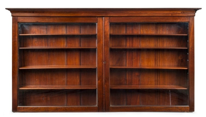 A rare Australian cedar two door wall cabinet with glazed doors and four adjustable shelves, full cedar construction, New South Wales origin, mid 19th century, 96cm high, 173cm wide, 19cm deep