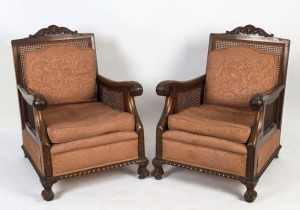 A pair of vintage cane sided armchairs with ball and claw feet, circa 1925, ​​​​​​​93cm high, 70cm across the arms