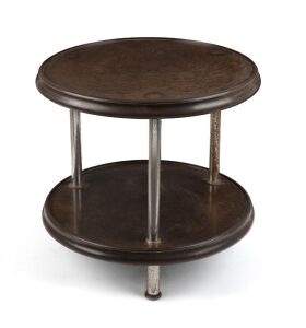 An Art Deco bakelite and metal two tiered occasional table, circa 1935, note pitting to chrome, 37cm high, 51cm diameter