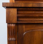 An Australian cedar bookcase with a cavetto pediment, two arch-top glazed doors, conforming lower panelled doors, an ogee-moulded drawer and carved corbels, 19th century, 235cm high, 114cm wide, 44cm deep - 2