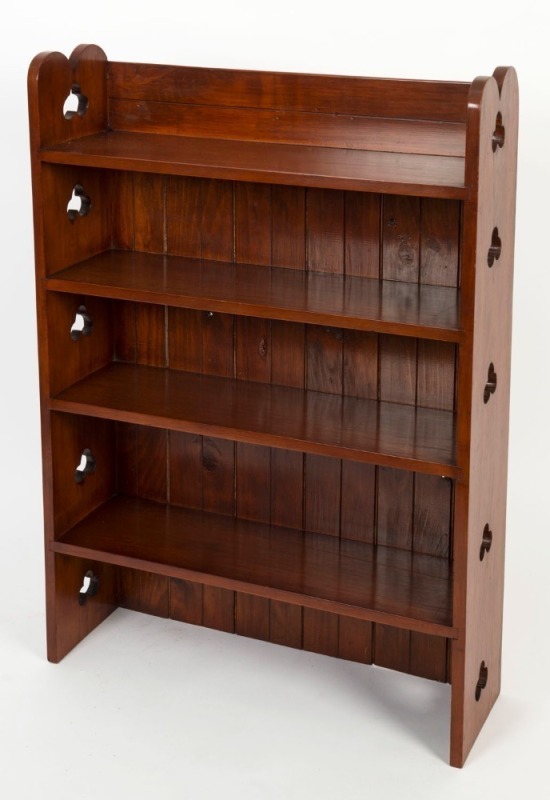 An Australian Arts & Crafts set of open bookshelves with pierced shamrock sides, circa 1920, 112cm high, 76cm wide, 23cm deep