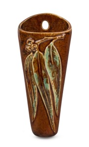 NELL McCREDY brown glazed pottery wall pocket with gumnuts and leaves, incised "Epping, NSW", with artist's monogram, 26cm high