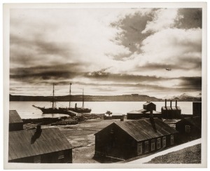 THE B.A.N.Z. ANTARCTIC EXPEDITION: Official original photograph by Captain Frank Hurley: Image A12 - Title: The Discovery, at Kerguelen Island, with official "MAWSON ANTARCTIC EXPEDITION" handstamp and release date "MONDAY FEB.24, 1930" verso, together wi