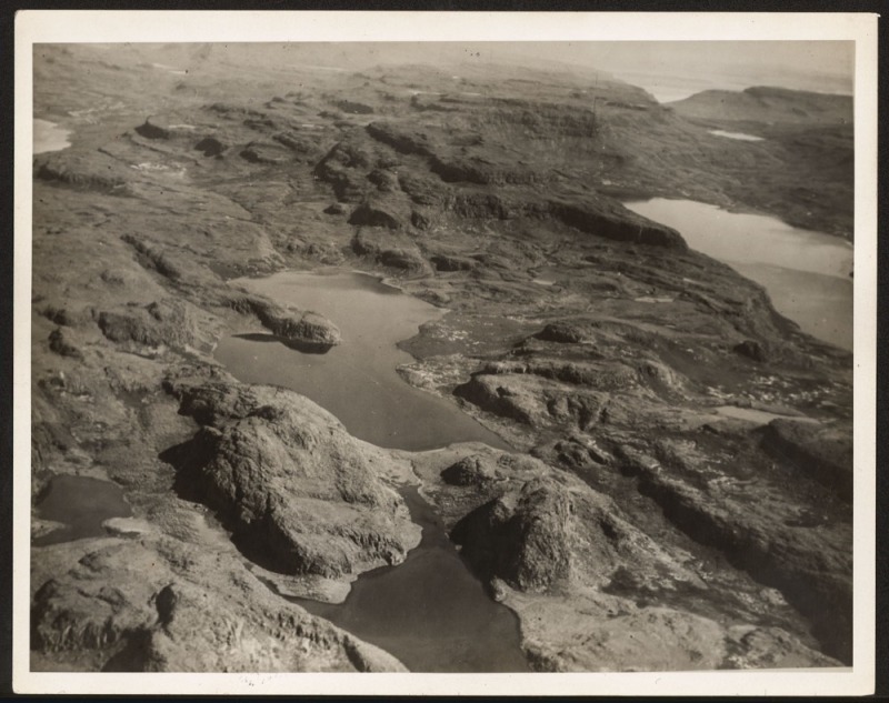 THE B.A.N.Z. ANTARCTIC EXPEDITION: Official original photograph by Captain Frank Hurley: Image A64 - Title: The Unexplored heart of Kerguelen, with official "MAWSON ANTARCTIC EXPEDITION" handstamp and release date "MONDAY MAY 12, 1930" verso, together wit