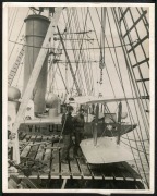 THE B.A.N.Z. ANTARCTIC EXPEDITION: Official original photograph by Captain Frank Hurley: Image A33 - Title: The Discovery's long arm. with official "MAWSON ANTARCTIC EXPEDITION" handstamp and release date "TUESDAY APR. 15, 1930" verso, together with the o