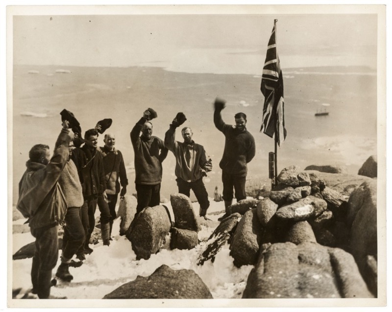 THE B.A.N.Z. ANTARCTIC EXPEDITION: Official original photograph by Captain Frank Hurley: Image A42 - Title: Cheering the Flag. with official "MAWSON ANTARCTIC EXPEDITION" handstamp and release date "MONDAY APR. 28, 1930" verso, together with the official