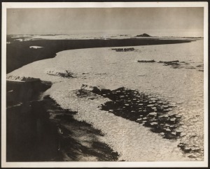 THE B.A.N.Z. ANTARCTIC EXPEDITION: Official original photograph by Captain Frank Hurley: Image A61 - Title: An Island looming above the icepacks. with official "MAWSON ANTARCTIC EXPEDITION" handstamp and release date "MONDAY MAY 12, 1930" verso, together 