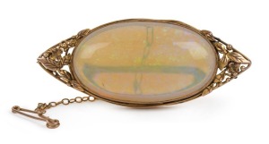 RHODA WAGER (attributed), stunning yellow gold brooch set with an impressive solid opal, early 20th century, ​​​​​​​6cm wide, 