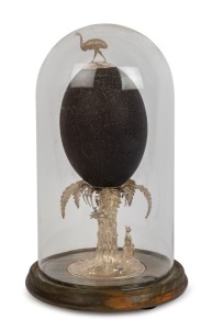 A sterling silver mounted emu egg ornament adorned with emu, kangaroo, cockatoo and possum, in glass dome on later timber base, stamped "Stg. Silver, Rocca", 25cm high