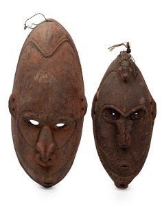 Two tribal masks, carved wood and fibre with remains of earth pigment decoration, Papua New Guinea origin, collected by John Leon Pender, an Australian ex-pat living in New Guinea in the 1930s and 40s who returned to Australia in 1942 upon the Japanese in