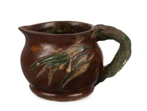 WILLIAM ANDERSON pottery jug with applied gumnuts, leaves and branch handle, glazed in brown and green, incised "W. S. Anderson, Lorne Clay", 11cm high, 17cm wide