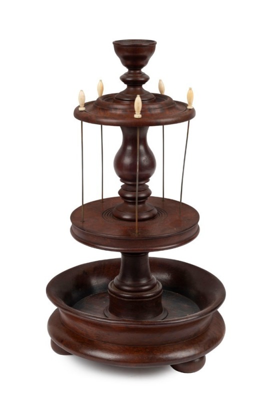 An antique colonial Australian cotton reel dispenser, blackwood, myrtle and cedar with whale bone finials, Tasmanian origin, early to mid 19th century,  36cm high