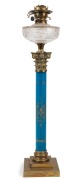 An antique kerosene banquet lamp, blue and gilt porcelain Corinthian column base with brass base and capital, cut crystal font, black button double burner with original blue acid etched glass shade and later chimney, 19th century, an impressive 107cm high - 3