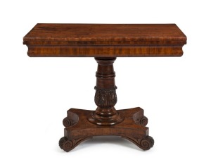 An impressive Colonial Australian cedar fold-over card table. Handsomely crafted in choice cuts of cedar with cross banded edge, cross grained ogee moulded frieze, finely carved and turned column, platform base and scrolling feet, Tasmanian origin, circa 