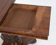 An impressive Colonial Australian cedar fold-over card table. Handsomely crafted in choice cuts of cedar with cross banded edge, cross grained ogee moulded frieze, finely carved and turned column, platform base and scrolling feet, Tasmanian origin, circa - 4