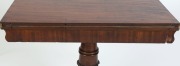 An impressive Colonial Australian cedar fold-over card table. Handsomely crafted in choice cuts of cedar with cross banded edge, cross grained ogee moulded frieze, finely carved and turned column, platform base and scrolling feet, Tasmanian origin, circa - 9