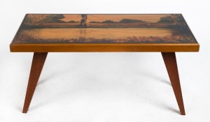 An Australian vintage coffee table, Kauri pine construction with hand-painted billabong native scene top. 20th century. 45cm high, 94cm wide, 50cm. 