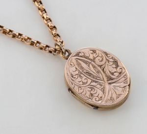 An antique 9ct gold chain with engraved oval locket, 19th century, the chain 64cm long, 11 grams