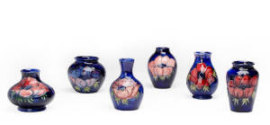 MOORCROFT: Group of 6 "Anemone" patterned vases on blue ground. Ranging in size from 7cm to 9cm&nbsp;