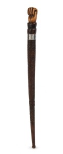 An antique Australian stock whip handle with fist finial, metal collar and carved decoration, 19th century, 42cm long