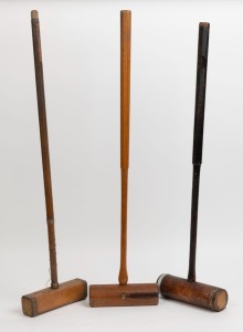 Three vintage wooden croquet mallets, the largest 97cm high