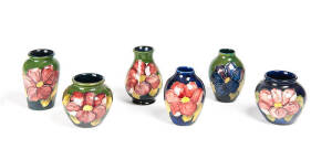 MOORCROFT: Group of 6 vases "Clematis" & "Anemone" patterns on blue & green grounds. Ranging in size from 7.5cm to 9.5cm