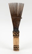 A tribal hair comb, carved tooth, wood and fibre, African origin,&nbsp; 23.5cm long