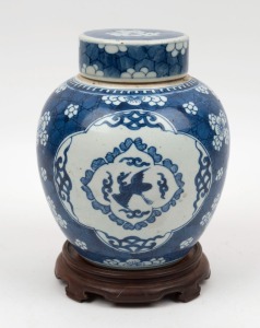 A antique Chinese blue and white porcelain ginger jar with carved timber base, 19th century, 24cm high overall