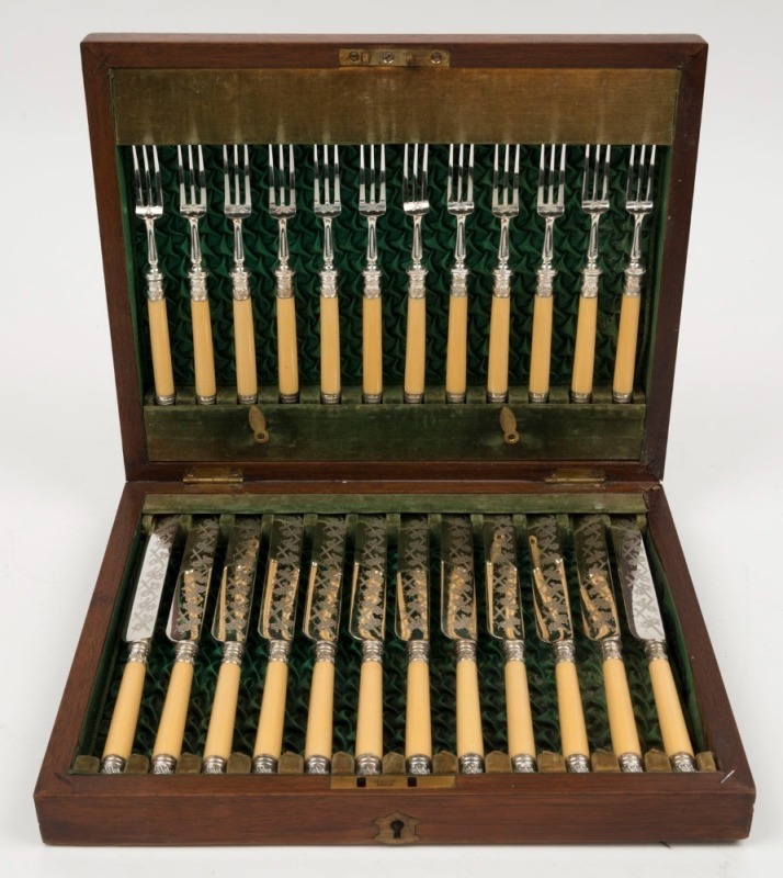 A 24 piece antique fruit cutlery set with turned ivory handles in original plush fitted box, 19th century,  the box 29cm wide