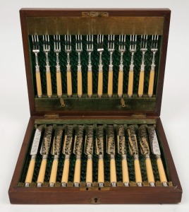 A 24 piece antique fruit cutlery set with turned ivory handles in original plush fitted box, 19th century, the box 29cm wide