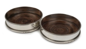 A pair of Georgian sterling silver wine bottle coasters, made in London early 19th century, 3.5cm high, 12.5cm diameter