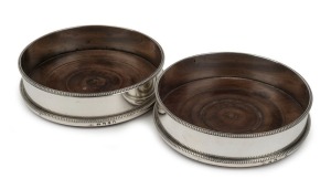 A pair of Georgian sterling silver wine bottle coasters, made in London early 19th century,  3.5cm high, 12.5cm diameter