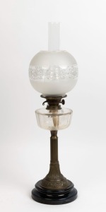 An antique banquet lamp with faceted crystal font, double burner, brass column with black ceramic base and replacement shade, ​​​​​​​74cm high