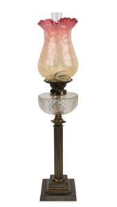 An antique English banquet lamp with cut crystal font, black button double burner with bayonet mount, Doric brass column, ruby and yellow vaseline glass shade, ​​​​​​​75cm high