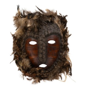 A tribal mask, tortoise shell, feather, earth and shell, unknown origin, 20th century, ​​​​​​​28cm high overall