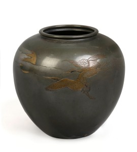 An antique Japanese bronze vase with flying crane decoration, inlaid with silver, copper and gold, Meiji period, 19th/20th century, engraved two character signature to the side, 22cm high