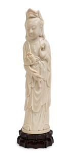 Guanyin carved ivory statue on carved wooden lotus base, 19th/20th century, 28cm high