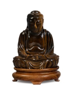 A Chinese seated Buddha statue, carved tiger's eye on wooden stand, 20th century, 14cm high overall
