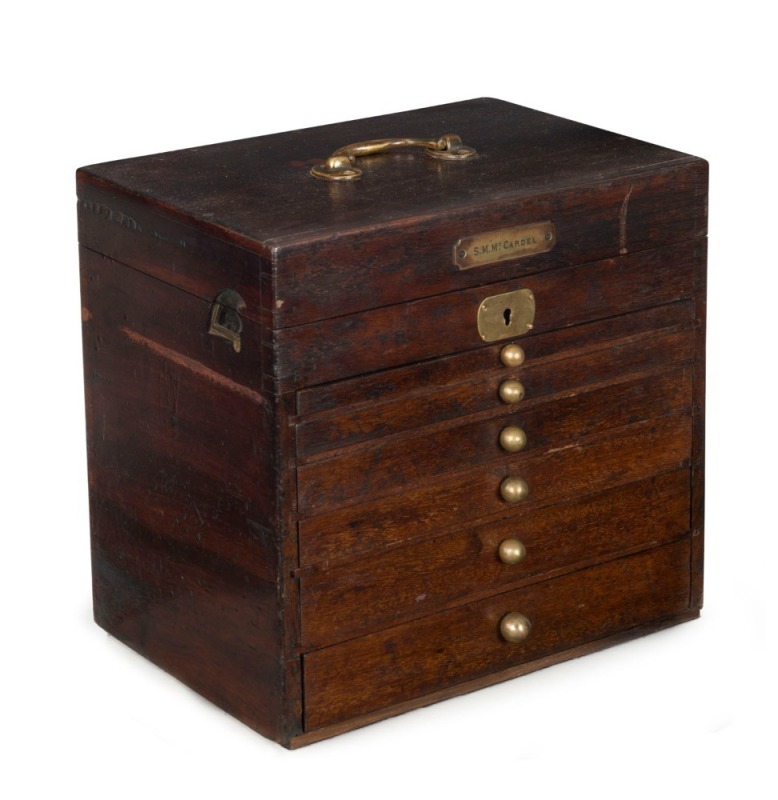 A collector's antique cabinet, mahogany and brass, fitted with drawers, compartments and brass plaque "S. M. McCardle", 19th century, 31cm high, 33cm wide, 23cm deep